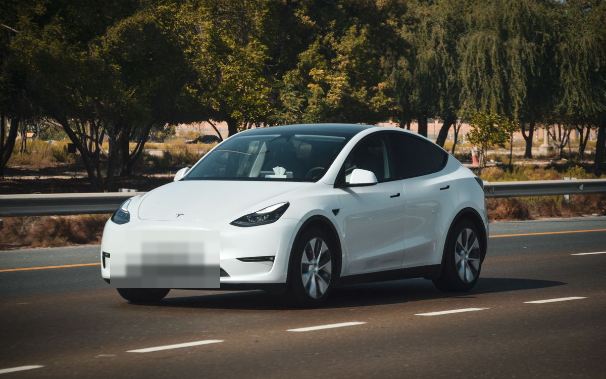 A white electric car on a road
