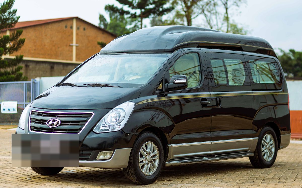 A black passenger van, photographed front three-quarter